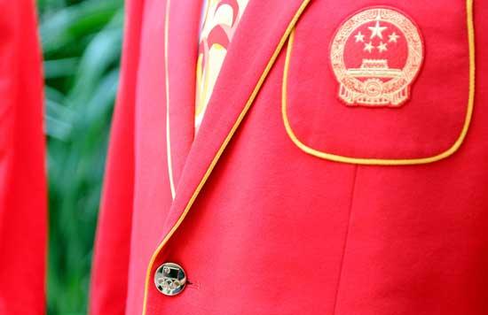 Chinese athletes show off the official uniforms for the Chinese national team for London Olympic Games at an unveiling ceremony in Beijing, June 25, 2012. (Photo/Xinhua)