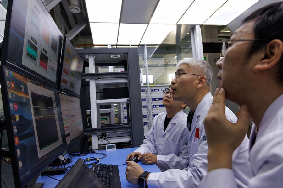 Researchers Li Gang, Liu Jianghua, and Zhou Benzhe (R-L) discuss the operational status of the all-superconducting magnet at the ultra-low temperature high magnetic field quantum oscillation experimental station of the Institute of Physics of the Chinese Academy of Sciences in Beijing, capital of China, on Jan. 26, 2026. (Xinhua/Jin Liwang)