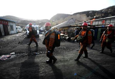 Rescuers walk out of the flooded Wangjialing Coal Mine after continuously working for more than 10 hours underground in north China's Shanxi Province, early on April 6, 2010. China witnessed miracles in its mining rescue history Monday as 115 workers were pulled out alive after being trapped for over a week in the flooded coal mine, and rescuers are continuing the search for 38 trapped miners.(Xinhua/Yan Yan)