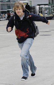 Red Bull Formula One driver Sebastian Vettel of Germany runs down he F1 Paddock on his arrival at the Shanghai International Circuit for the the Chinese Formula One Grand Prix in Shanghai, China, Thursday, April 15, 2010.