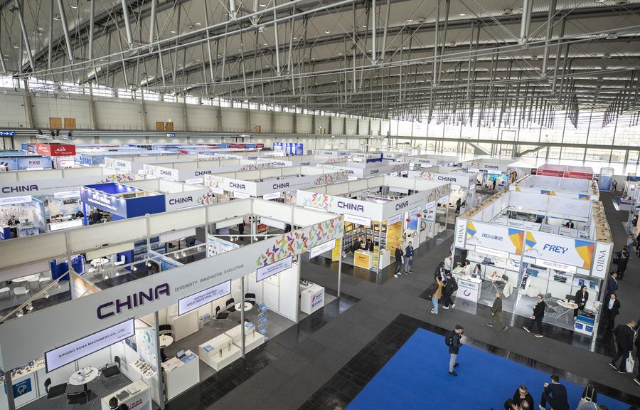 People walk past exhibition area of Chinese companies at Hannover Messe 2025 in Hannover, Germany, on March 31, 2025.