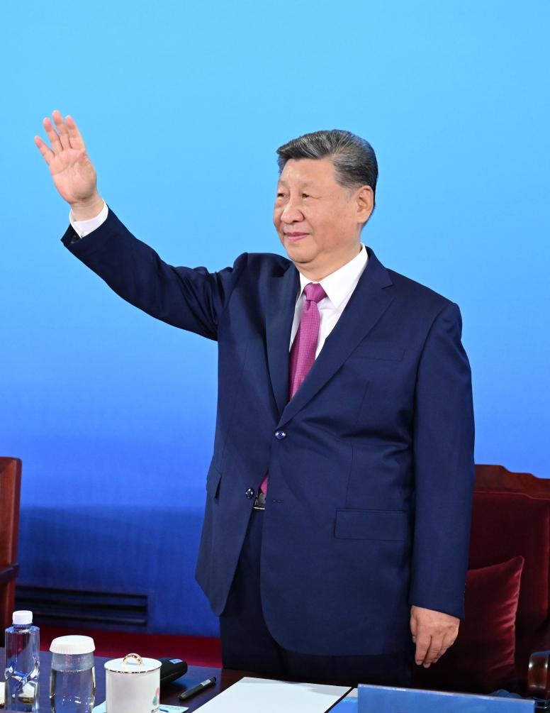 Chinese President Xi Jinping, also general secretary of the Communist Party of China Central Committee and chairman of the Central Military Commission, waves during the opening ceremony of China