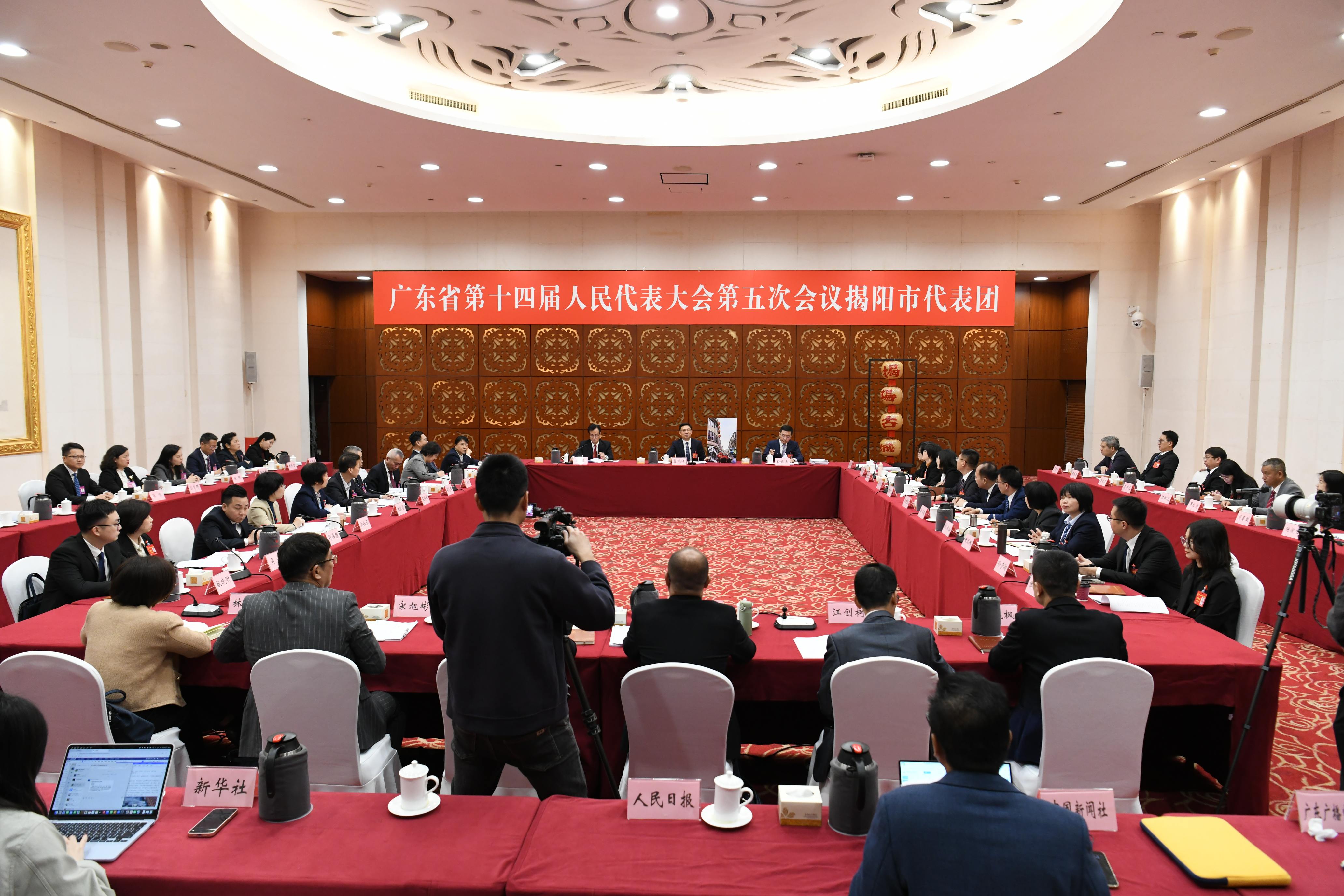 广东省人大代表、揭阳市委书记曾风保（中）展示揭阳古城照片。